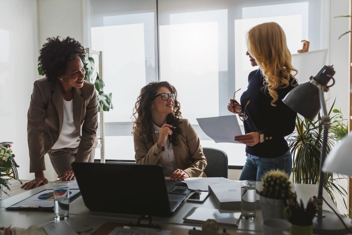 Group of diverse businesswomen discussing new project Group of diverse businesswomen discussing new project